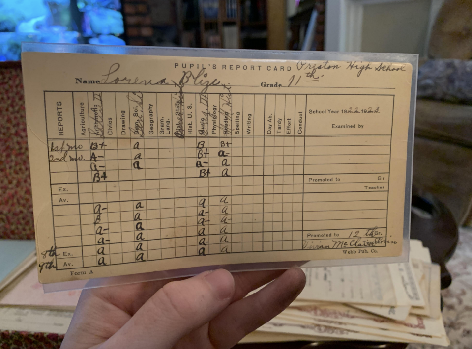 A hand holds an old report card showing grades. Student mostly received As, with some Bs. School year is 1948-1949 from Virginia High School