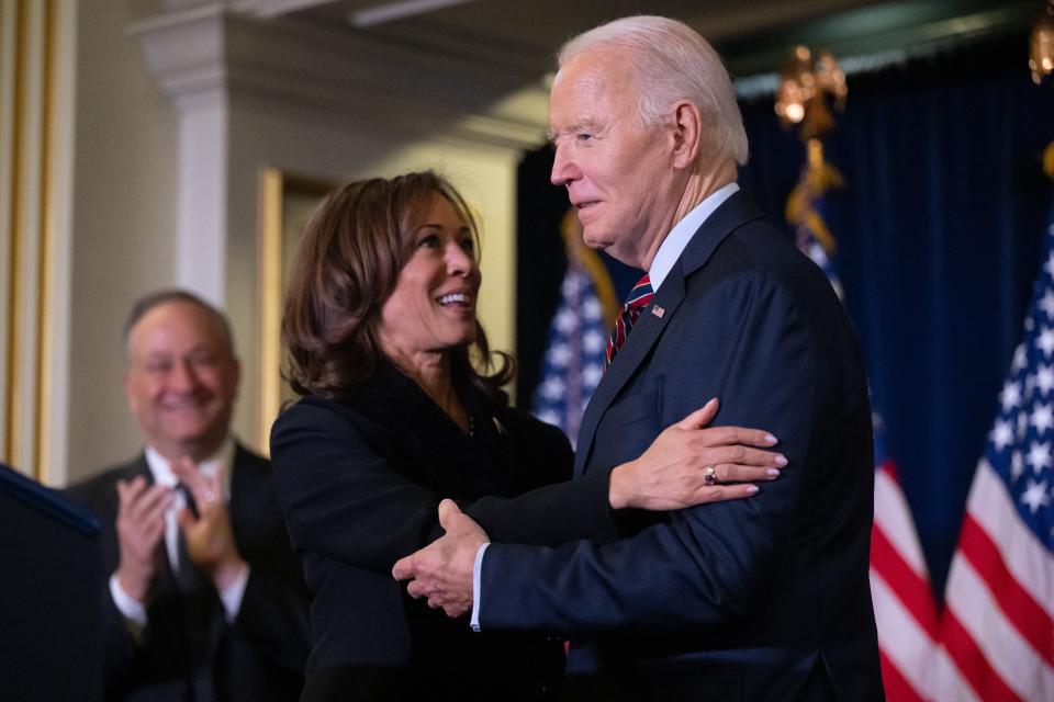 Vice President Kamala Harris embraces President Joe Biden prior to speaking during the Democratic National Committee's Holiday Reception in Washington, DC, Dec. 15, 2024.