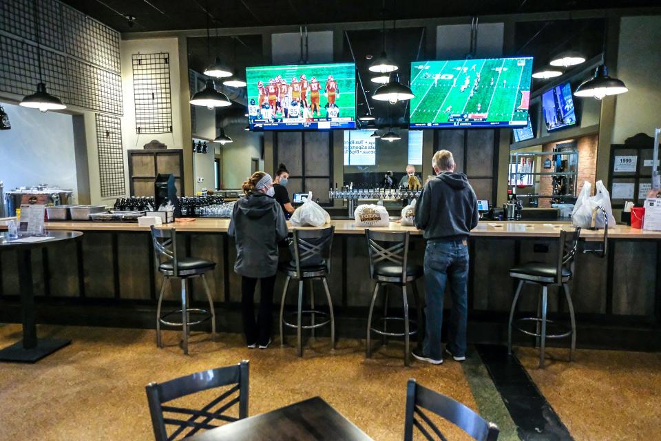 Customers get their takeout orders at St. Johns Brewing Co. Saturday, Dec. 12, 2020.