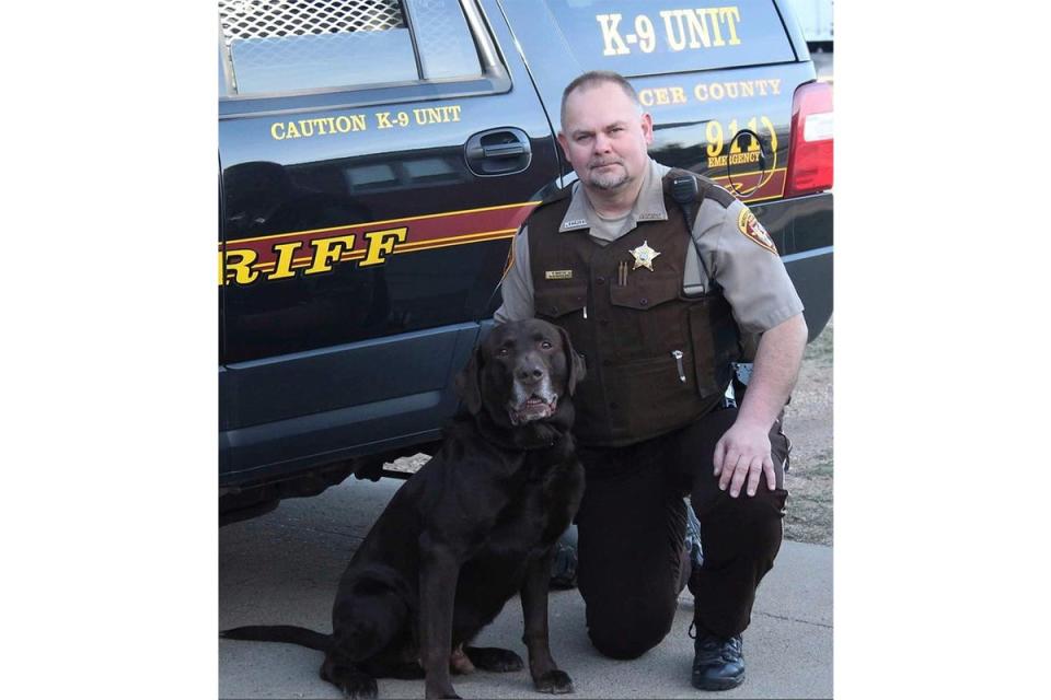 Mercer County Sheriff&#x002019;s Deputy Paul Martin (pictured with his retired K9 Goliath) was killed during the incident a year ago (AP)