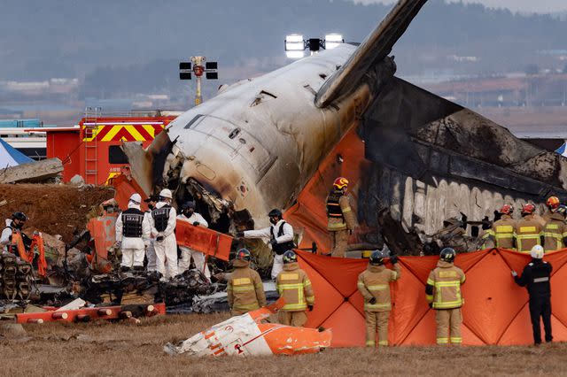 Chris Jung/NurPhoto via Getty Fire authorities search for the missing and recover the deceased at the site of an accident near Muan International Airport in Jeollanam-do, South Korea, on Dec. 29, 2024