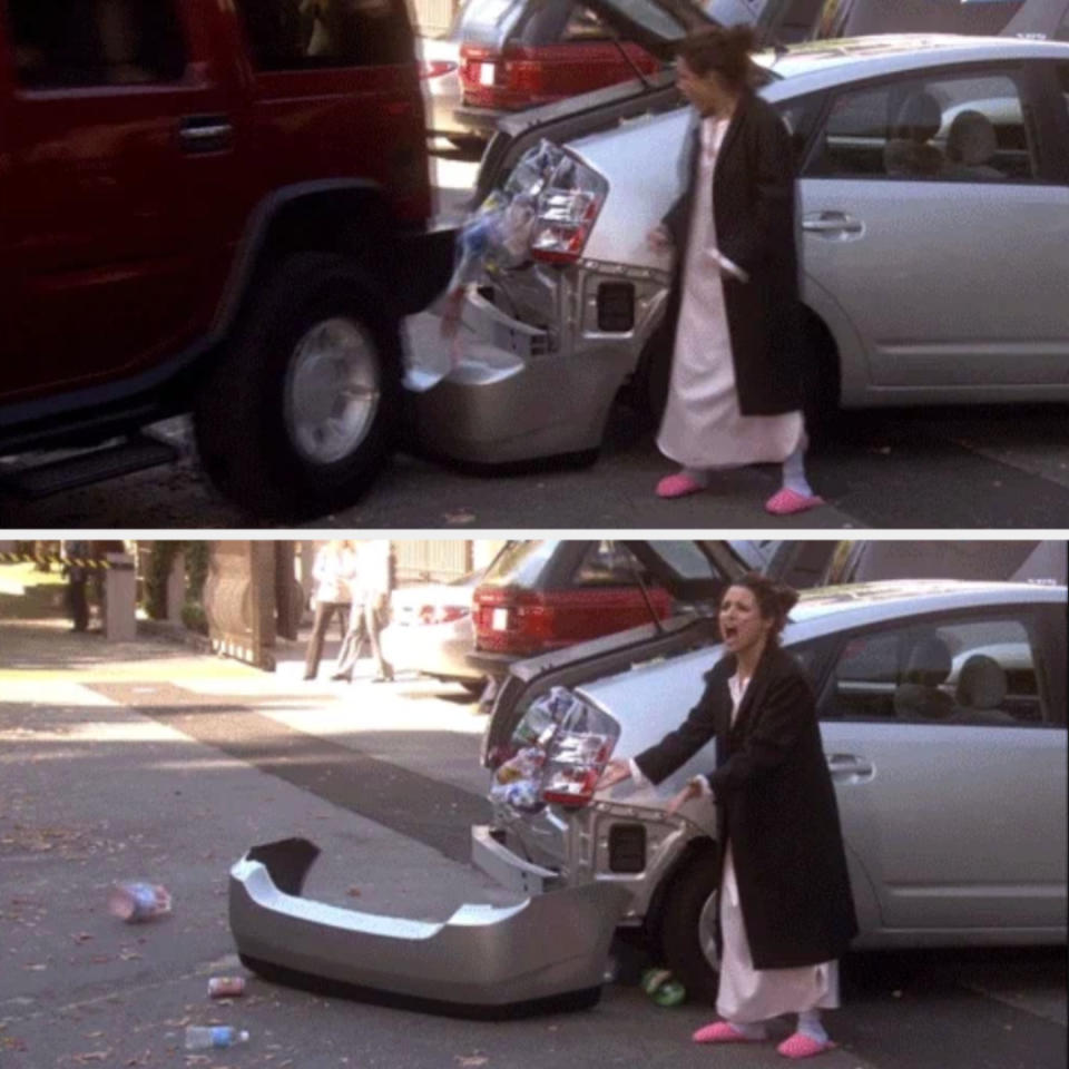 A person in a bathrobe and slippers reacts to a rear-end car collision, showing a car&#x002019;s damaged bumper and scattered trash on the street