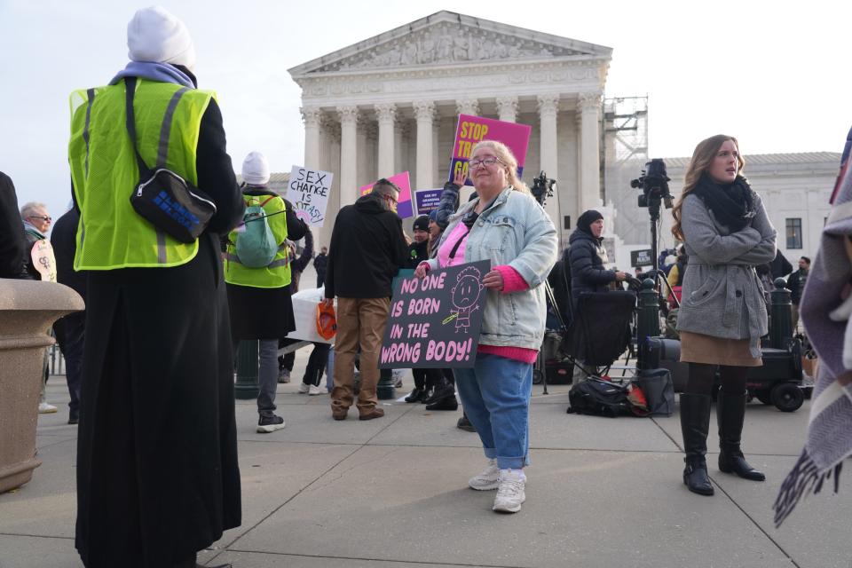 Dawn Land, an anti-transgender activist, holds a sign outside the U.S. Supreme Court in Washington, D.C. on Wednesday, Dec. 4, 2024. Justices on Wednesday will consider states’ ability to prevent transgender adolescents from using puberty blockers and hormone therapy. How the conservative court decides the transgender rights case out of Tennessee could affect not just access to specific medical treatments across much of the country, but could also impact ongoing legal challenges to other rules targeting transgender people, such as those restricting bathroom use and sports competition.