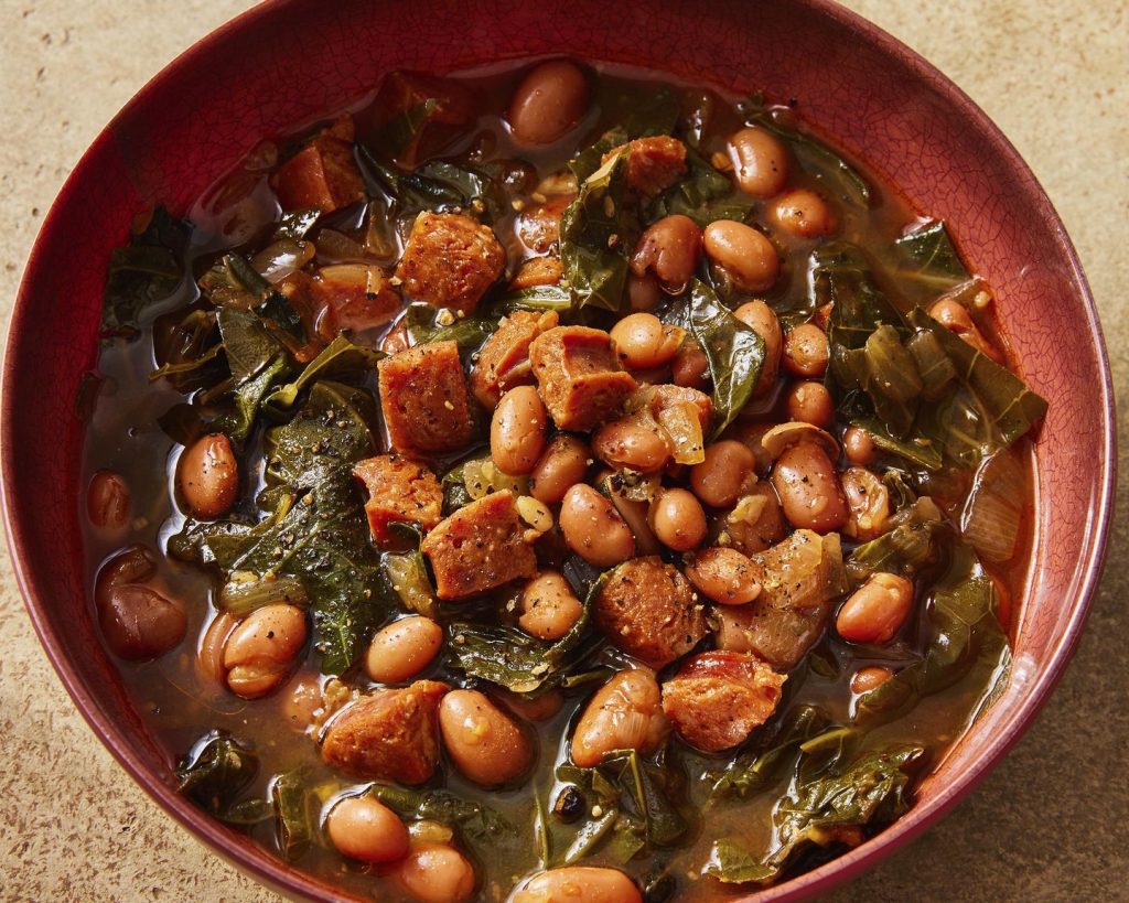 Flavorful chorizo brings meaty depth to a paprika pinto bean soup with collard greens