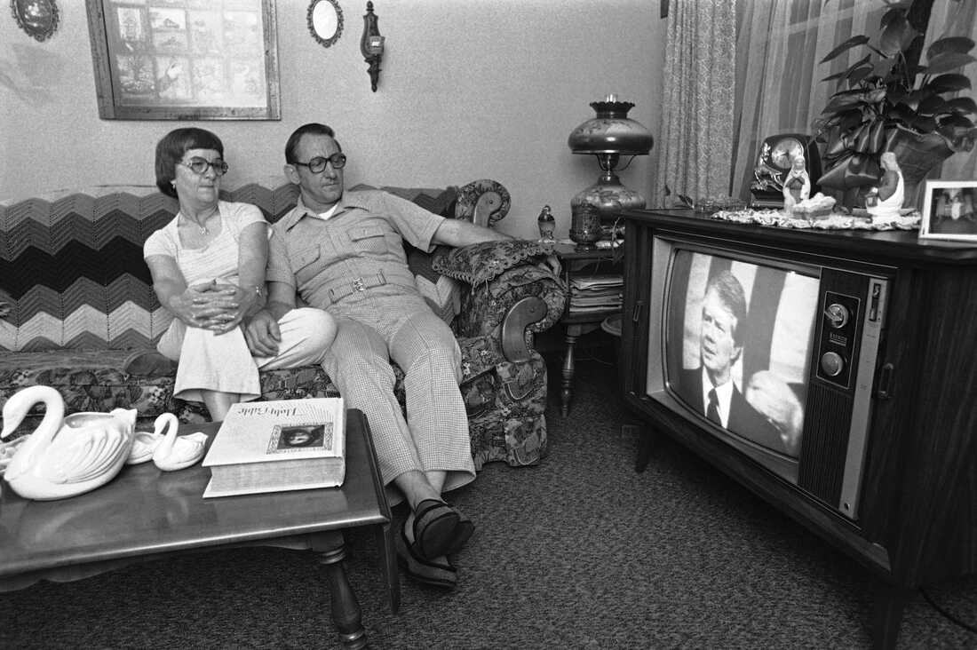 Ed and Mary Cashat of Pasadena, Texas, listen to the address on energy by President Carter before a joint session of Congress on April 21, 1977. Ed Cashat is a foreman of the operations department that handles machinery and equipment at a Shell Oil Company refinery.