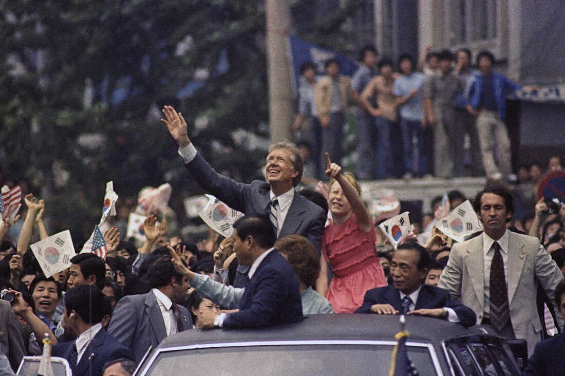 President Carter, his daughter Amy, South Korean President Park Chung-hee and others wave during a motorcade in Seoul on June 30, 1979.