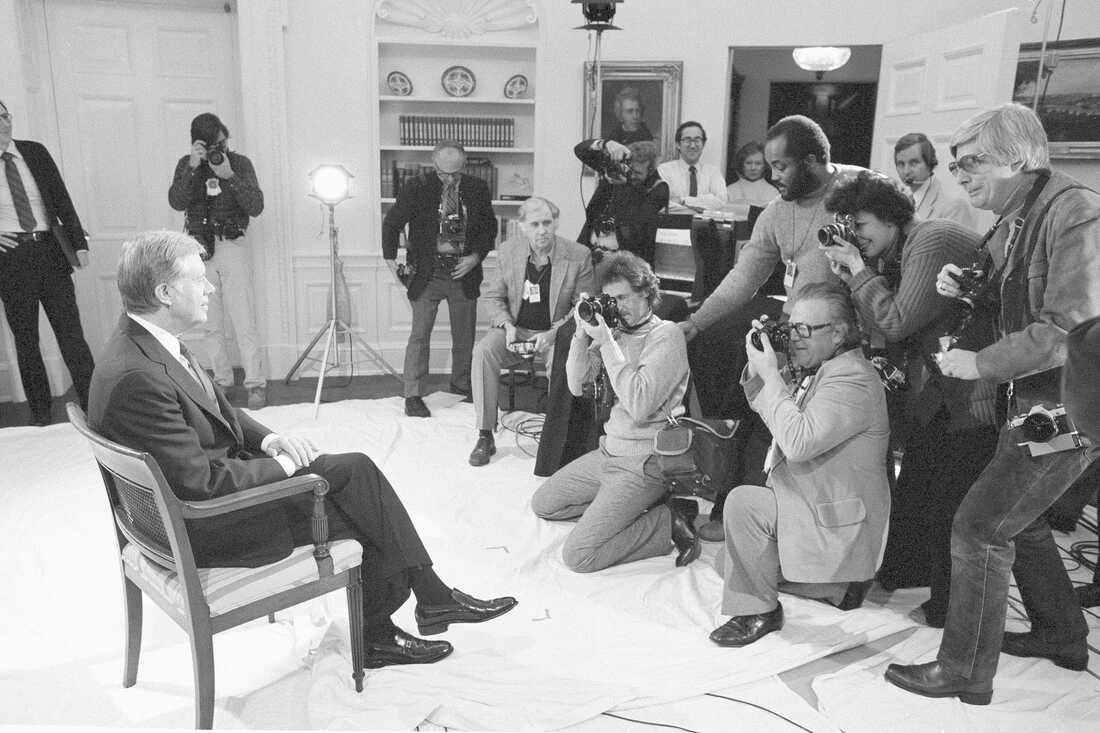 President Carter poses for photographers in the Oval Office on Jan. 14, 1981, just prior to delivering his farewell address on national television.