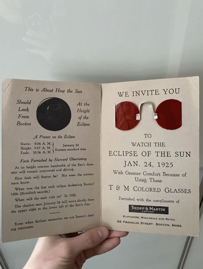 Open pamphlet inviting viewers to a solar eclipse event on Jan. 24, 1925, featuring protective glasses for viewing