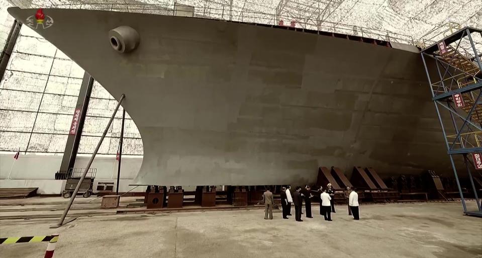 A view of the bow of the vessel, with shipyard officials and Kim in attendance, reveals its impressive size. <em>KCNA</em>