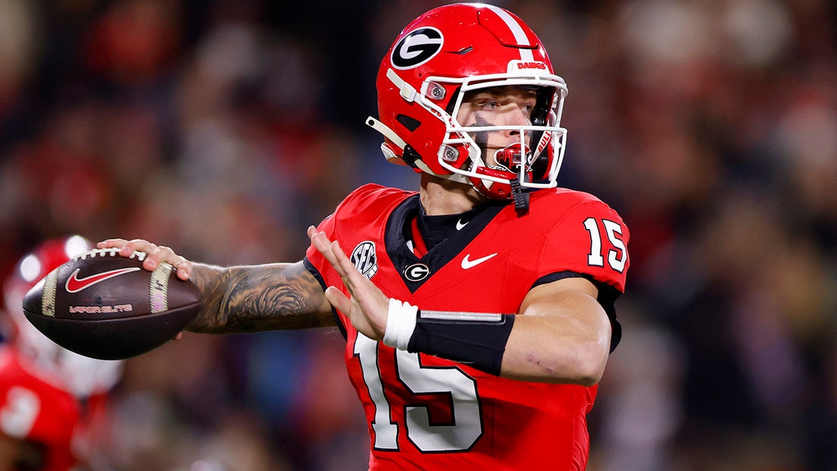 Carson Beck throws a pass