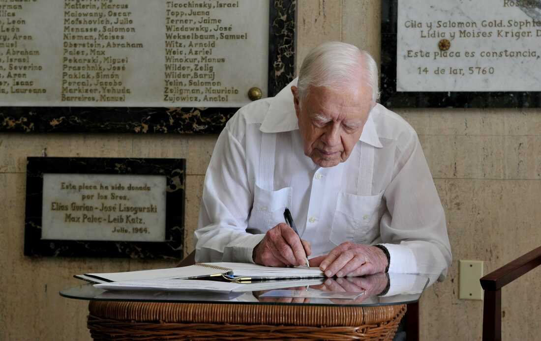 March 28, 2011: Former President Jimmy Carter signs his name in the guest book at the Jewish Community center in Havana, Cuba, Monday March 28, 2011. Carter arrived in Cuba to discuss economic policies and ways to improve Washington-Havana relations, which are even more tense than usual over the imprisonment of Alan Gross, a U.S. contractor, on the island. C (AP Photo/Adalberto Roque, Pool)