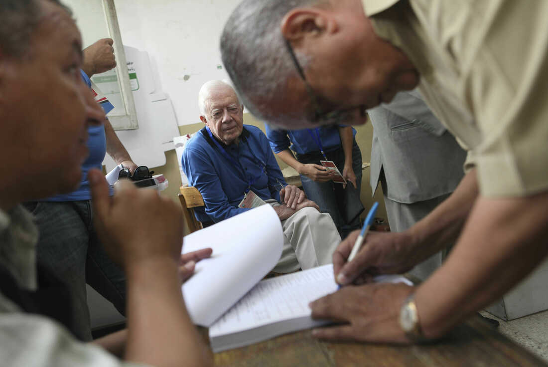 May 23, 2012: former U.S. President Jimmy Carter, center, observes the election process inside a polling station in the Sayeda Aisha neighborhood of Cairo, Egypt. Carter was warning Egypt that its transition to democracy after years of political turmoil is faltering ahead of presidential elections planned for later this month, in a statement Friday, May 16, 2014.