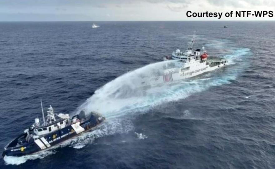 In this image taken from a video provided by the Philippine National Task Force for the West Philippine Sea (NTF-WPS), a Chinese coast guard vessel, right, fires a powerful water cannon at a Philippine bureau of fisheries vessel near a disputed shoal in the South China Sea, Dec. 4, 2024.&nbsp; / Credit: Aaron Favila/NTF-WPS via AP