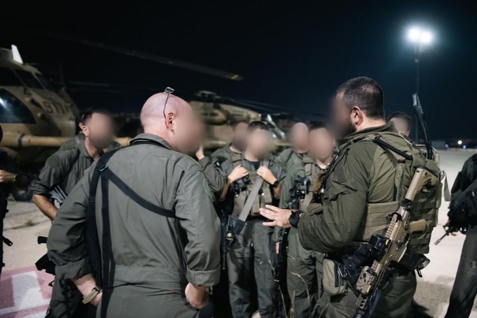 IAF personnel discuss the raid after returning to Israel. <em>IDF</em>