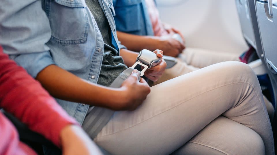 People often forget how to unbuckle their seatbelt in the stress of an airplane evacuation, says Galea. - urbazon/E+/Getty Images