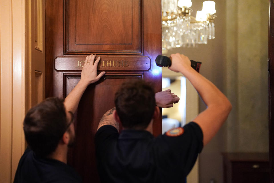 Workers for the Architect of the Capitol place Sen. John Thune’s nameplate on the Republican Leader’s suite in the U.S. Capitol, replacing McConnell’s name, which has been there for the last 18 years. (Frank Thorp V / NBC News)