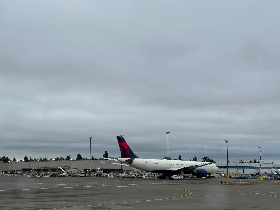 A Delta Air Lines jet under cloudy skies at Seattle-Tacoma International Airport on June 27, 2024.