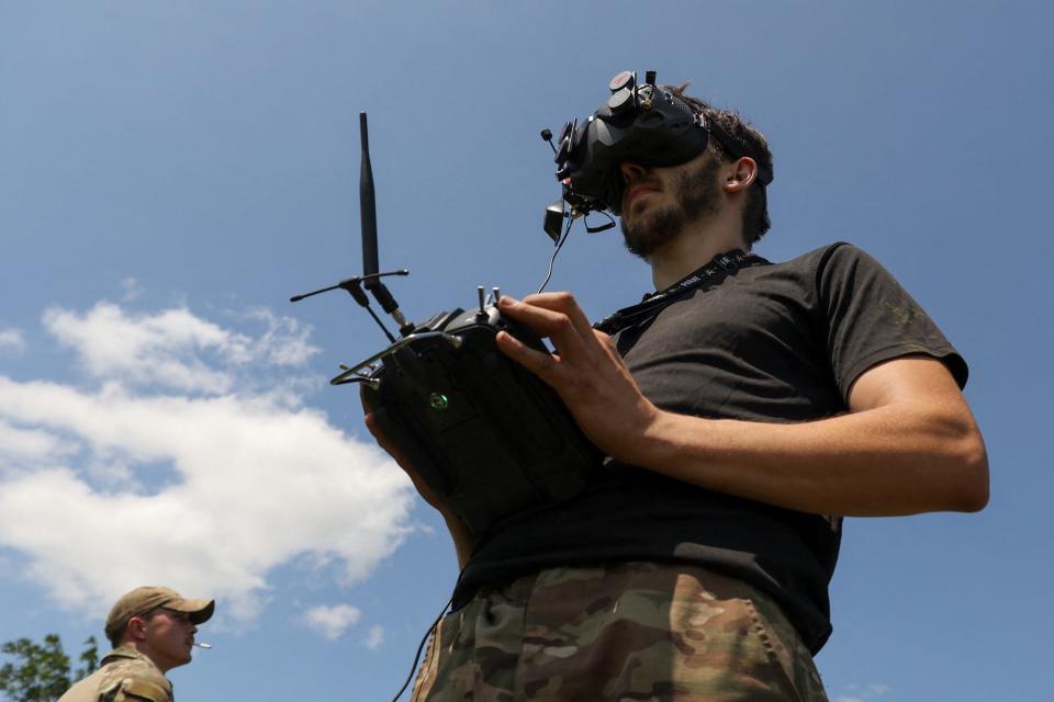 A Ukrainian serviceman with goggles and a remote control.