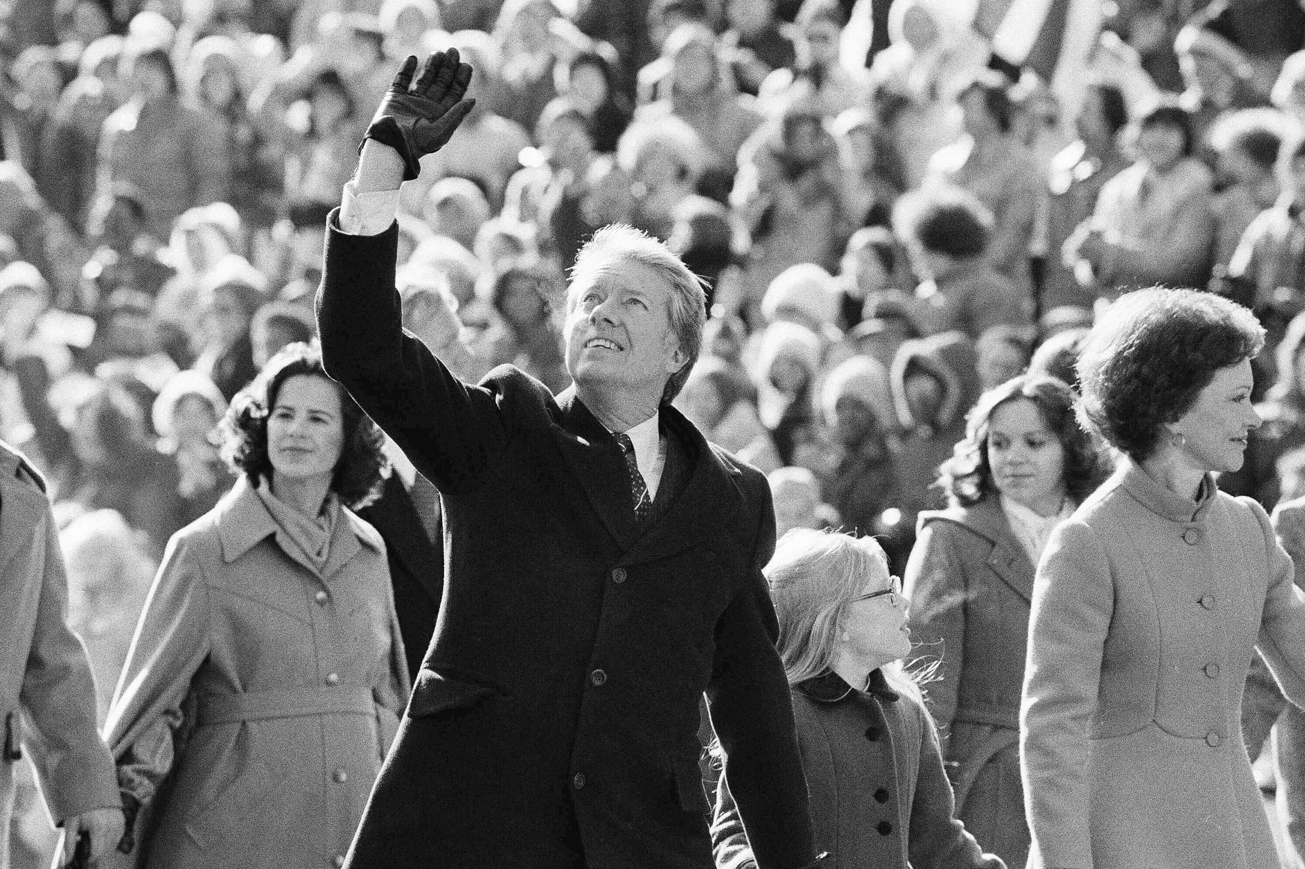 President Jimmy Carter waves to the crowd while walking with his wife, Rosalynn, and their daughter, Amy, along Pennsylvania Avenue from the Capitol to the White House following his inauguration in Washington, D.C., on Jan. 20, 1977. On the following day, he issued a pardon for people who had evaded the Vietnam War draft.