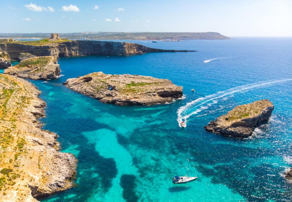 aerial view of comino island and a few boats o the sea drone landscape europe malta