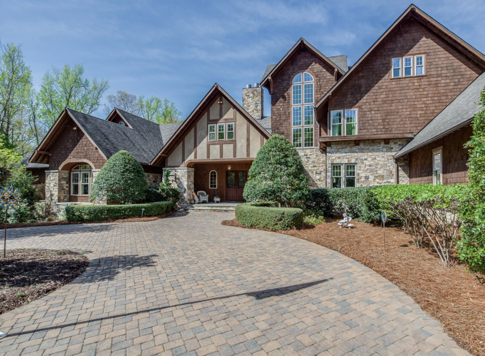 The 17,000-square-foot estate graces 11 gated, waterfront acres at 9235 Sweetleaf Place on Lake Wylie.