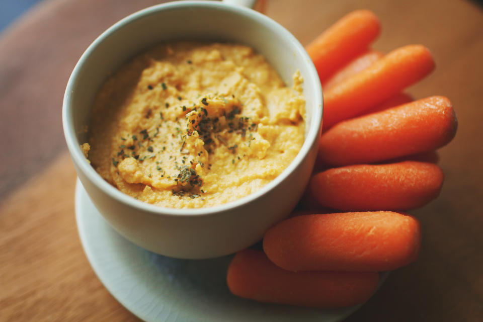 Savory pumpkin rosemary hummus with carrots.