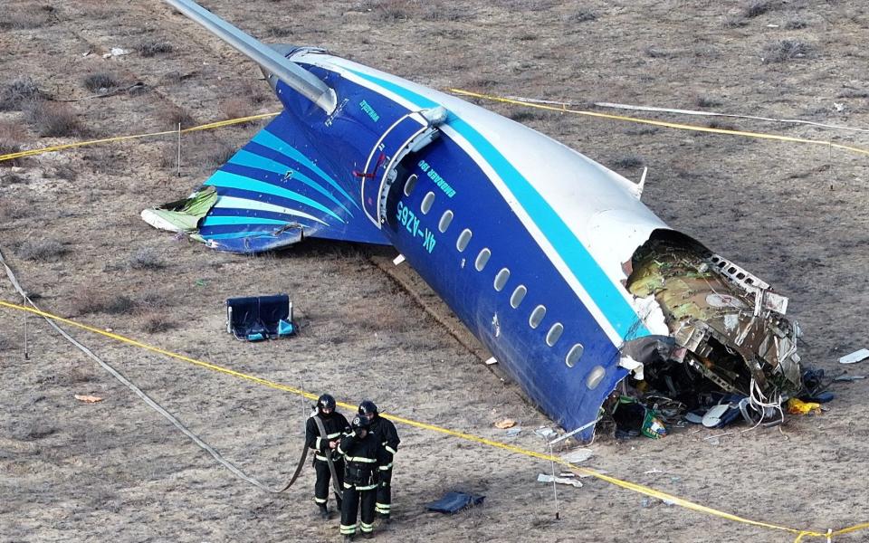 A drone view shows emergency specialists working at the crash site of an Azerbaijan Airlines passenger plane near the city of Aktau, Kazakhstan