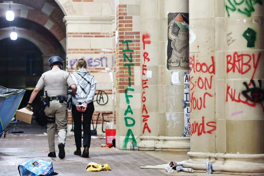 LOS ANGELES, CALIFORNIA – MAY 02: A California Highway Patrol (CHP) officer detains a protestor while clearing a pro-Palestinian encampment after dispersal orders were given at the University of California, Los Angeles (UCLA) campus, on May 2, 2024 in Los Angeles, California. (Photo by Mario Tama/Getty Images)