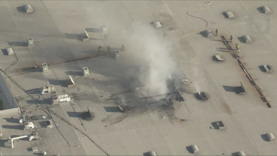 <em>Smoke billows from the top of a warehouse in Fullerton where a plane crashed Thursday afternoon, Jan. 2, 2025. (KTLA)</em>