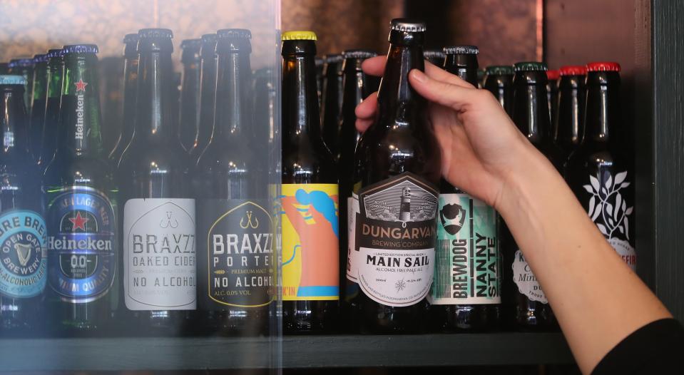 Alcohol-free beers in a row on a shelf.