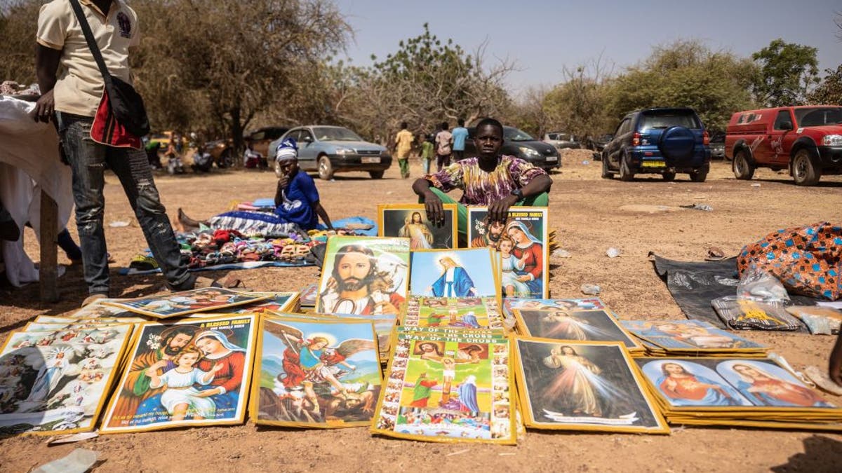 A boy sells objects of piety during a pilgrimage to Yagma on the outskirts of Ouagadougou, on Feb. 5, 2023. Thousands of pilgrims from several dioceses of Burkina Faso prayed for peace on February 5, 2023 at the national pilgrimage of Yagma, on the outskirts of Ouagadougou. The Marian shrine of Yagma has hosted the Christian pilgrimage every year at the beginning of the year for more than fifty years. The national pilgrimage takes place every three years.