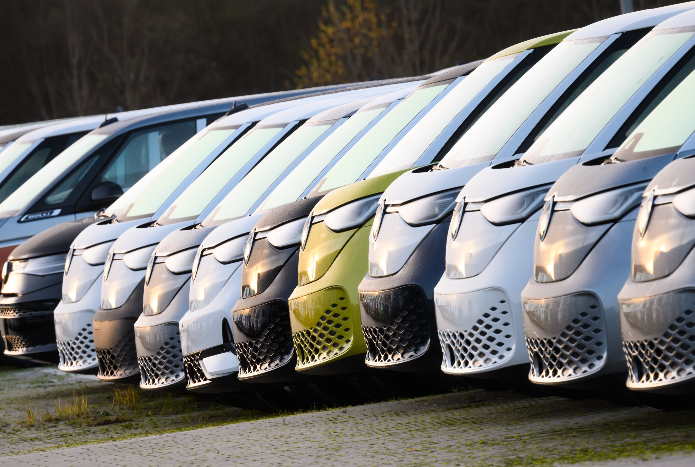 New VW ID.Buzz electric buses are parked in a parking lot at the Volkswagen Commercial Vehicles plant.