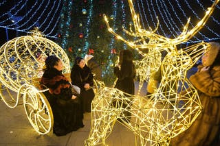 Visitors enjoy Christmas decorations in the centre of Russian-controlled Mariupol