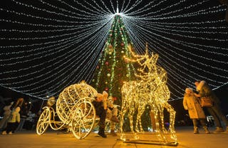 Visitors enjoy Christmas decorations in the centre of Russian controlled Mariupol