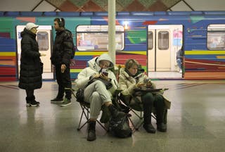 Local residents take shelter in a metro station during an air strike alarm in Kyiv