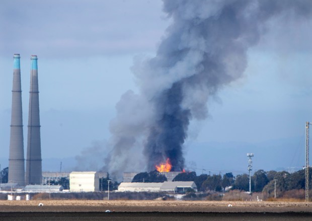 Smoke and flames are seen from Castroville as a fire...