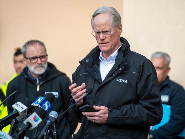 Peter Ziegler, vice president of operations at Vistra Energy, left, listens to Vistra's senior director of community affairs, Brad Watson, as he talks about the fire at the battery storage facility in Moss Landing during a press conference in Castroville, Calif., on Friday, Jan. 17, 2025. (Doug Duran/Bay Area News Group)