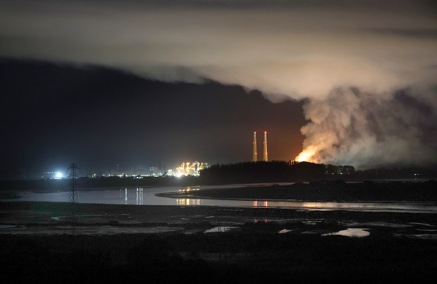 Elkhorn Slough winds toward the Monterey Bay as fire blazes...