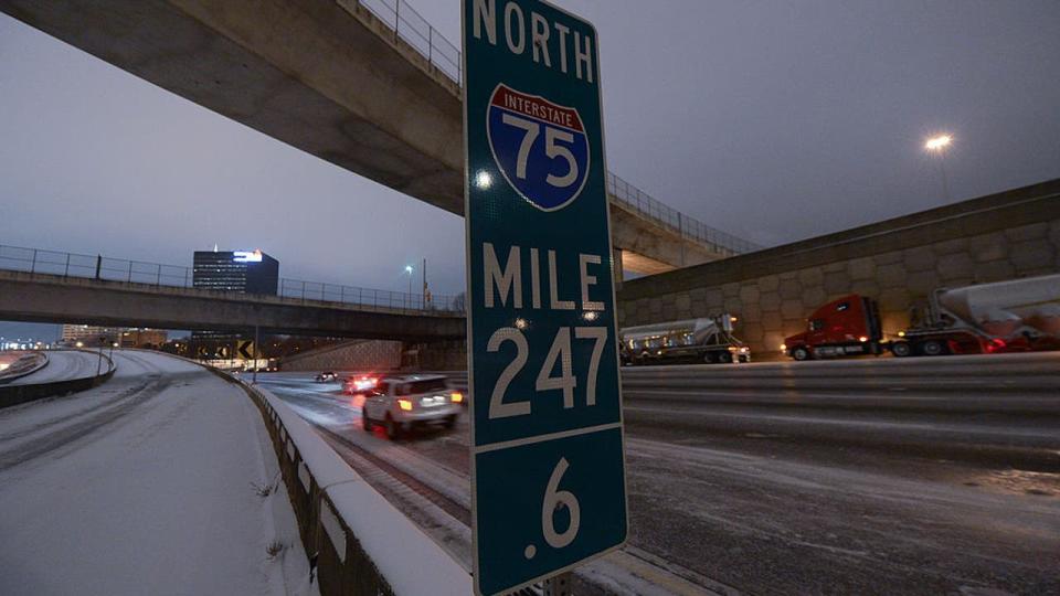 <div>Traffic on Interstate 75/85 deals with snow and ice conditions on January 28, 2014 in Atlanta, Georgia. A rare winter storm has brought ice and snow across the southern states closing schools and stranding motorists.(Photo by Prince Williams/Getty Images)</div>