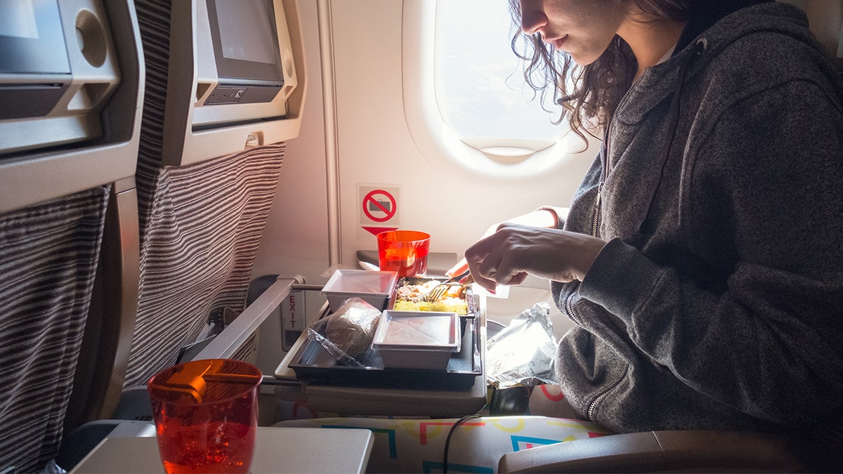 Person eating airline food.