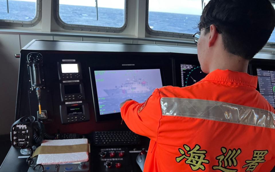 A member of Taiwan&#39;s coast guard monitoring a Chinese coast guard ship on Dec 9. &#39;Unusual movements&#39; of seven such vessels were detected off Taiwan between  Dec 6 and Dec 9