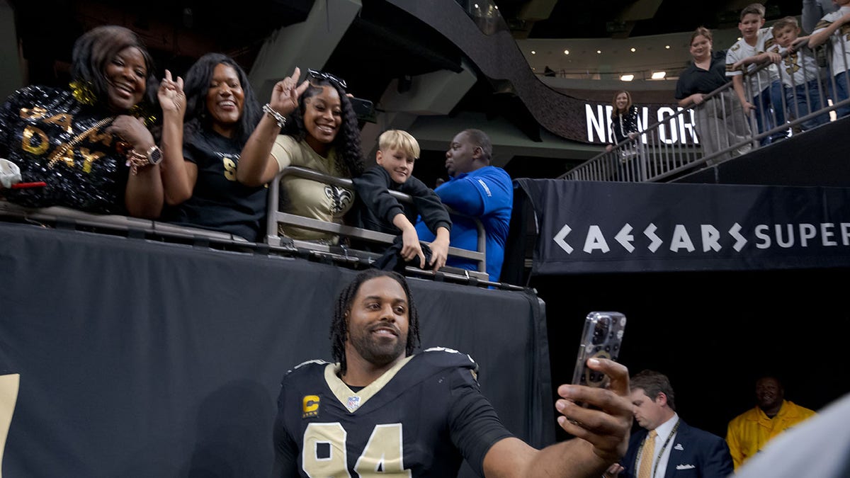 Cam Jordan takes selfie with fans