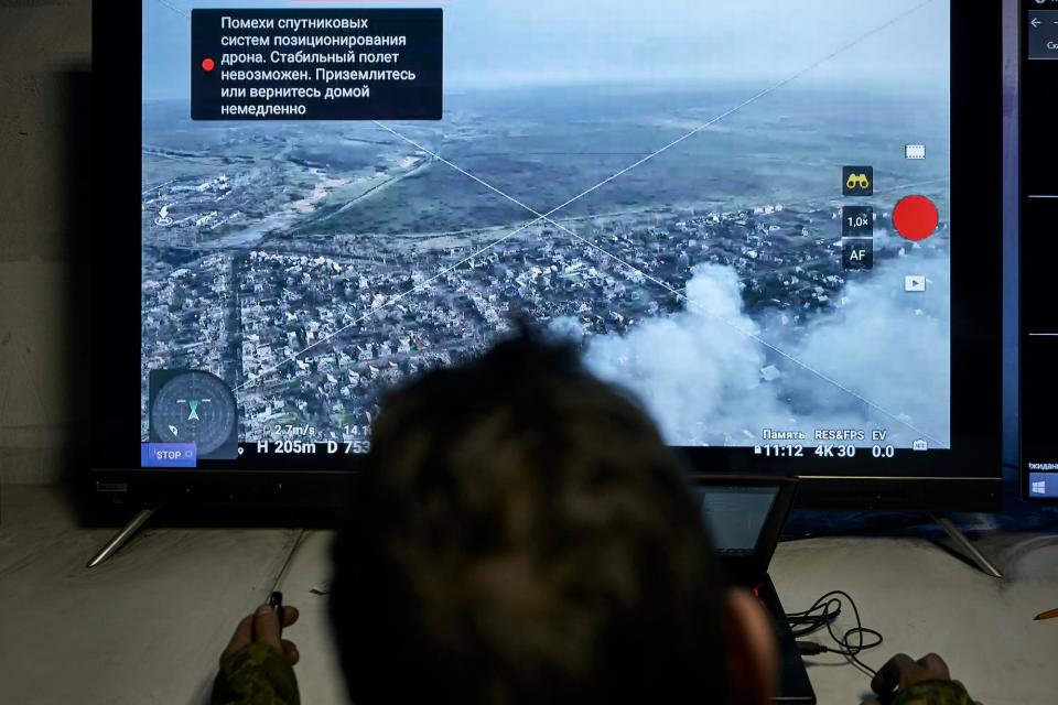 A Ukrainian soldier watches a drone feed from an underground command center in Bakhmut