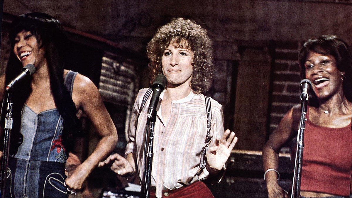 Barbra Streisand performing alongside two women in a scene from A Star is Born