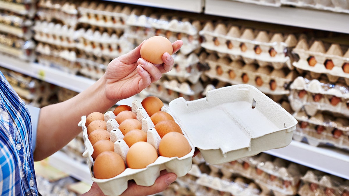 a woman packing eggs in the supermarket