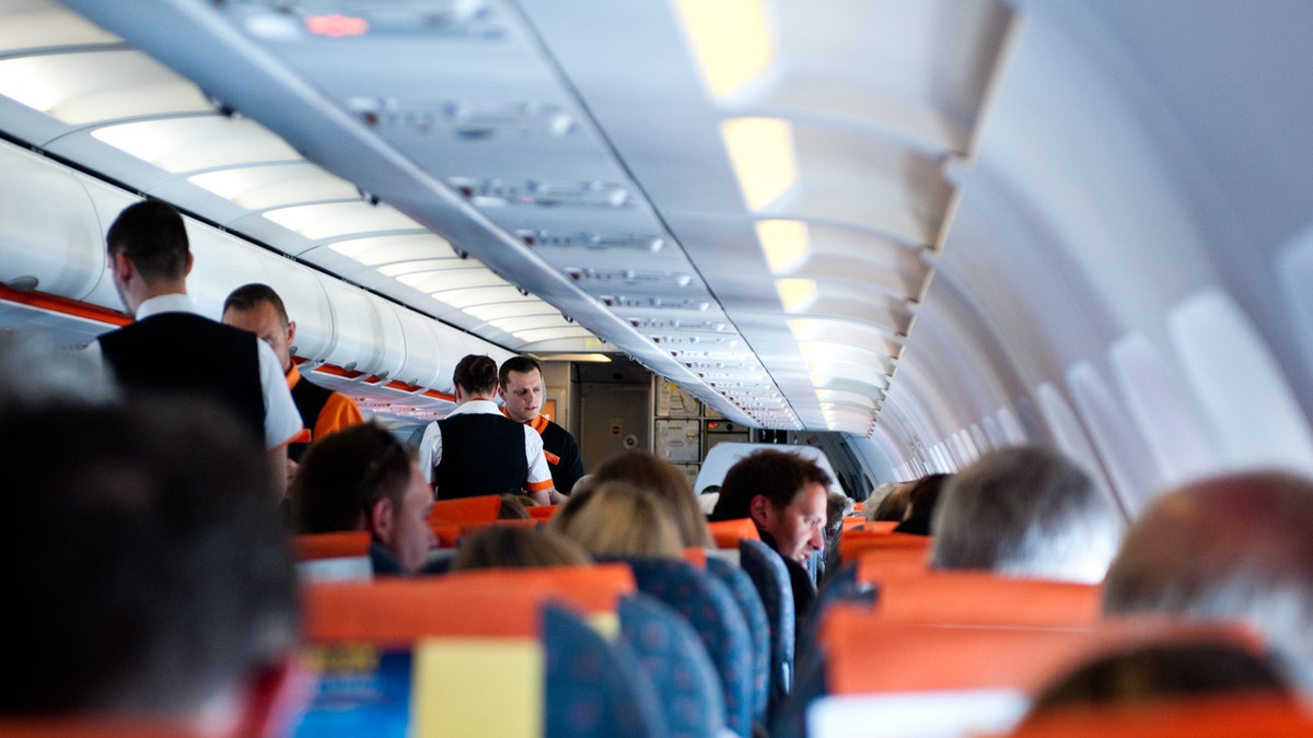 flight passengers sitting in plane seats