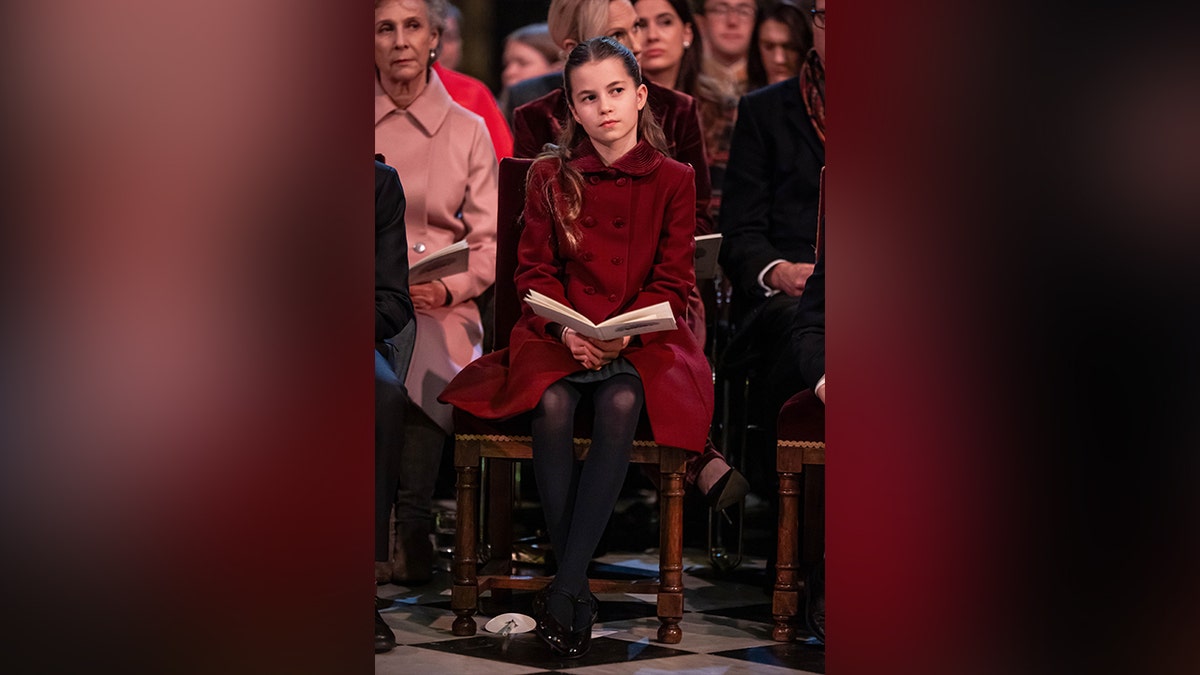 Princess Charlotte in a red coat.