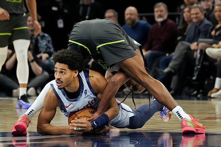 Timberwolves guard Rob Dillingham goes for the ball against Washington Wizards guard Jordan Poole in the third quarter at Target Center on Saturday.