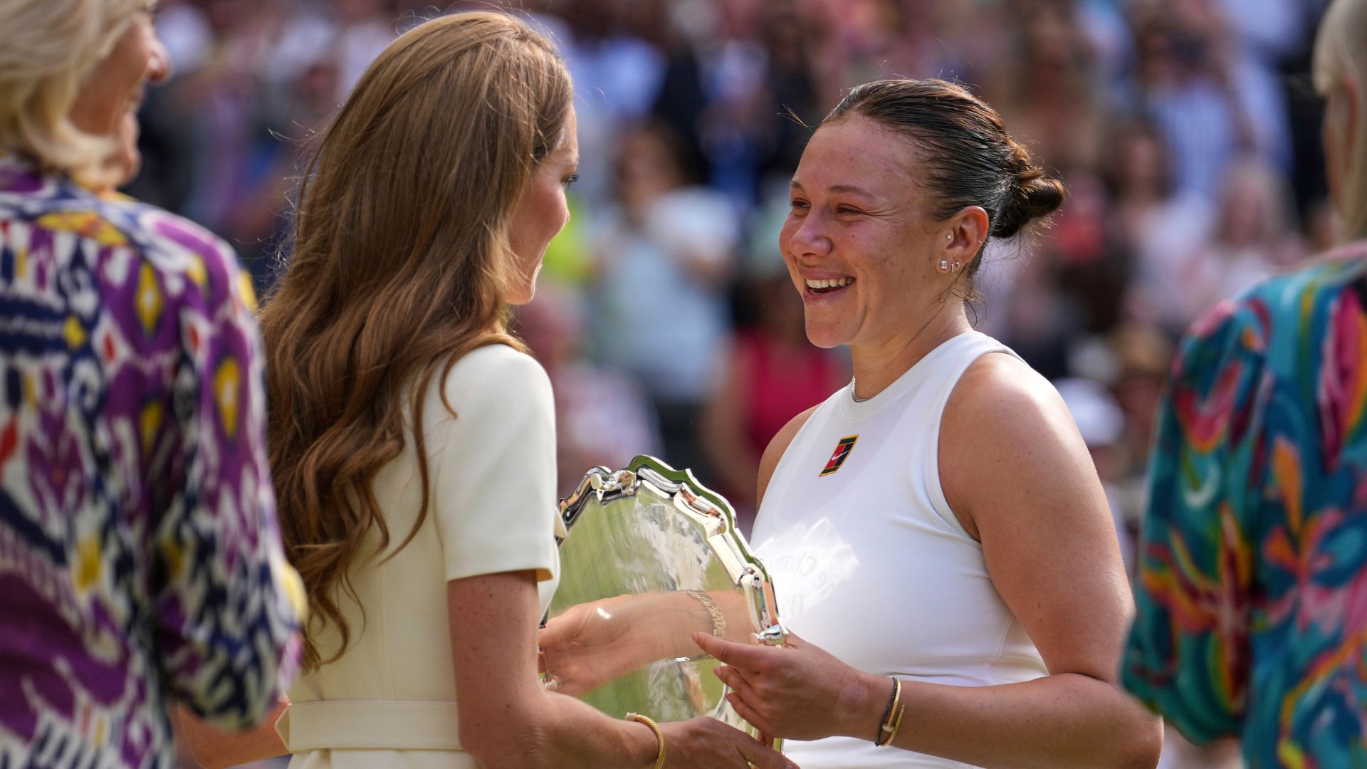 Amanda Anisimova receives her runners-up trophy from Kate, Princess of Wales, after losing to Iga Swiatek in the Wimbledon women's single final in London, July 12, 2025.